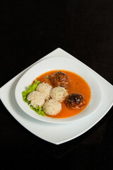 Traditional roasted meatballs with rice and tomato sauce