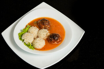 Traditional roasted meatballs with rice and tomato sauce