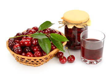Glass of juice, basket of red cherries and jar of jam isolated on white