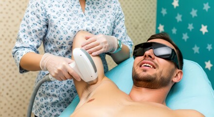 Woman technician performing laser hair removal on man’s armpit. Unwanted hair on male body. Modern epilation procedure at beauty clinic.