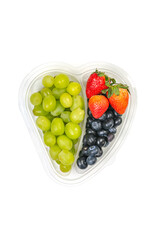 Grapes, blueberries and strawberries in a clear plastic container.