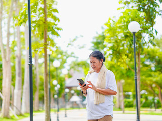 Happy senior woman enjoying using smartphone for online shopping, research browser, chat...