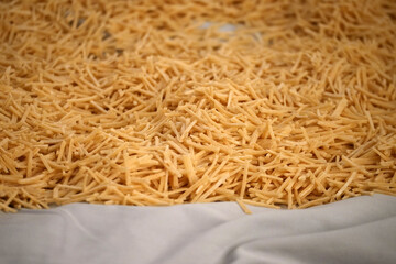 Cutting noodles from homemade natural wheat flour dough,