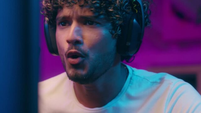 Arabian Latino Muslim American man streamer talking tell microphone streaming online male excited worried guy anxiety emotions radio host cyber sport playing computer game pc blog vlog player at home