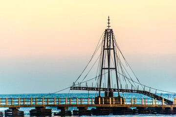Broken suspension bridge at Pigeon Island, Matara, Sri Lanka during sunset – coastal structure...