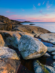 Coastal sunset near Gothenburg reveals serene rock formations and tranquil waters