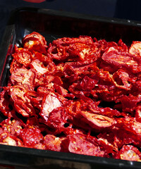 drying tomatoes in the sun, finely chopped tomatoes are dried on the balcony,
