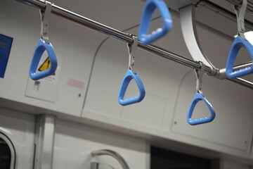 Closeup of Blue Handgrips Inside Modern Metro Train in Vietnam