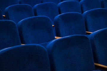 Blue empty seats in the audience prepared for the participants of the conference or presentation