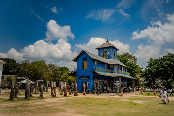 Devinuwara Uthpalawanna Sri Vishnu Maha Dewalaya in Sri Lanka – vibrant blue temple with visitors...