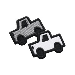 Two embroidered patches featuring simple truck designs, one in gray and other in white, are displayed. patches have playful and minimalist style, suitable for clothing or accessories