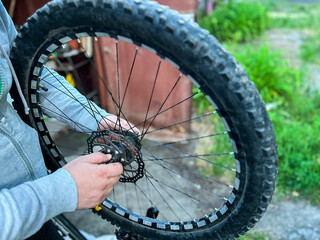 Mechanic repairing bicycle wheel with disc brake rotor