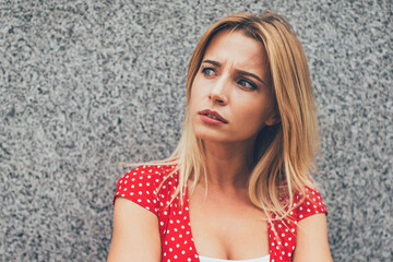 Worried serious woman standing in street