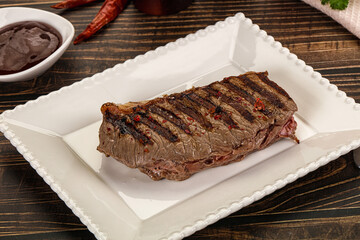 Grilled beef striploin steak with sauce