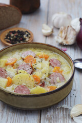 A bowl with traditional German potato soup with sausages