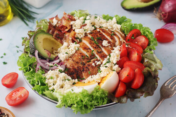A bowl with cobb salad, traditional American dish