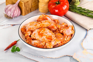 Raw marinated uncooked chicken wings