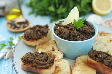 A bowl with tapenade - traditional olive dip in Mediterranean region