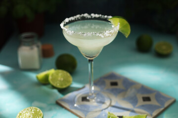 A glass with margarita cocktail with lime