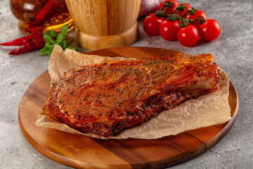 Raw marinated pork loin steak