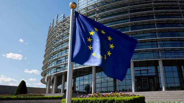 EU Flag Waving Against Clear Blue Sky and Government Architecture