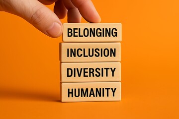 Building blocks with empowering words Belonging, Inclusion, Diversity, and Humanity arranged together to represent social harmony and connection