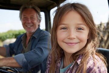 Happy granddaughter smiling with grandfather driving tractor in summer