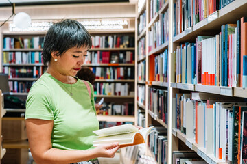 Customer reading a book in a bookstore, surrounded by shelves full of colorful books