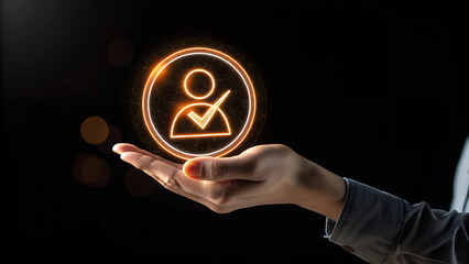 Hand holding a glowing user profile icon with a check mark on a dark background