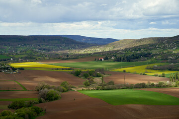 Obraz premium Tranquil Springtime Rural Hungary: Agricultural Fields, Easter Village, Family Homes, Vineyards, Forest, Pastoral Landscape