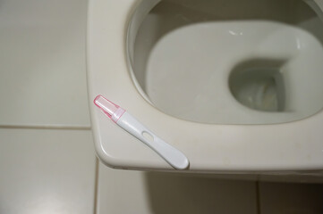 Pregnancy test on the toilet. 