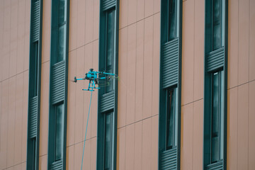 A drone cleaning a facade of a building