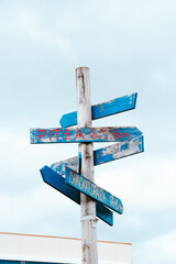 Old worn signs to different places 