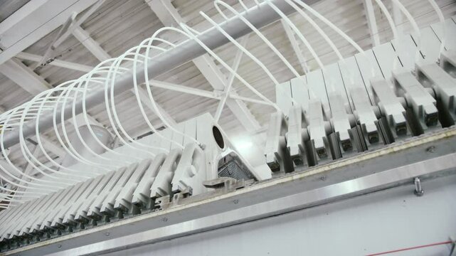 Complex machinery at a beer bottling plant operates at high speed, showcasing advanced technology and automated processes in the beverage industry