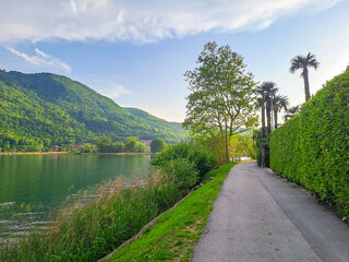 Spring view of Lake Lugano in the town of Caslano in the Swiss mountains.