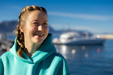 Woman in marina with yacht on a background
