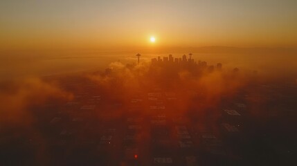 Naklejka premium Sunrise over a city shrouded in fog
