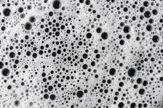 Black foam bubbles texture. Abstract closeup background. Soap surface with dark foam cells. Macro pattern detail. Clean structure. Artistic minimalist concept. Chemistry and texture.