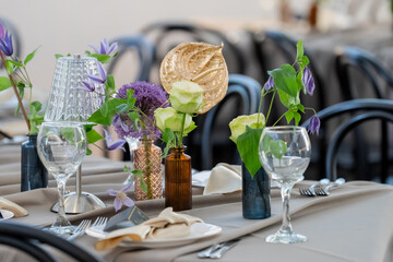 decorations of green flowers in modern restaurant catering table for fresh summer dinner setting