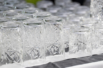 White transparent cocktail glasses upside down after being washed ready for cocktail drinking in...