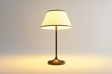 Obraz premium Elegant table lamp with a soft glowing shade, perfect for cozy interiors and adding warmth to living spaces.