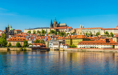 A view across the Vltava river beside the Charles bridge in Prague in springtime