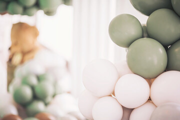 Delicate balloon arrangement adds charm to a celebration with a soft color palette and a backdrop...