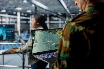 Team of military experts in data center doing mission coordination, operating satellite lock...