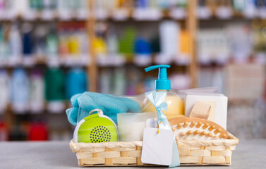 Beautifully arranged wicker self-care gift basket with skincare and bath products, wrapped with ribbon, displayed on store counter, perfect for holiday gifting