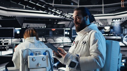 Cosmonaut using tablet in spaceship conducting safety checks during mankind survival expedition....