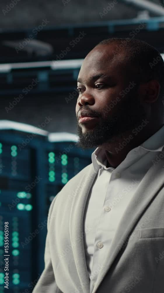 Poster vertical video smiling engineer in server hub monitoring data center energy consumption across compo