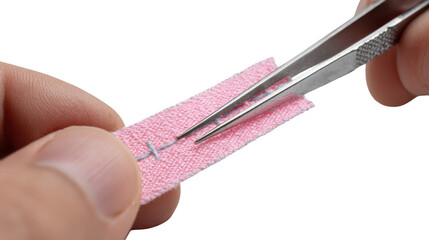 Close up of a tailor using tweezers to carefully remove stitches from pink fabric, highlighting precision and attention to detail with a transparent background for versatile design use