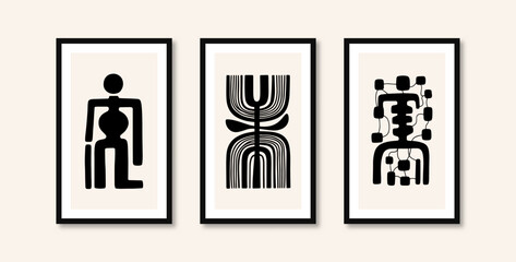 
Abstract art of three different paintings of humanoids made with thick lines on paintings mounted on the wall