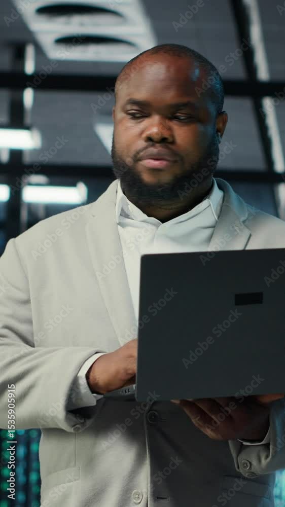 Poster vertical video engineer walking in data center using ai automation during maintenance session. afric